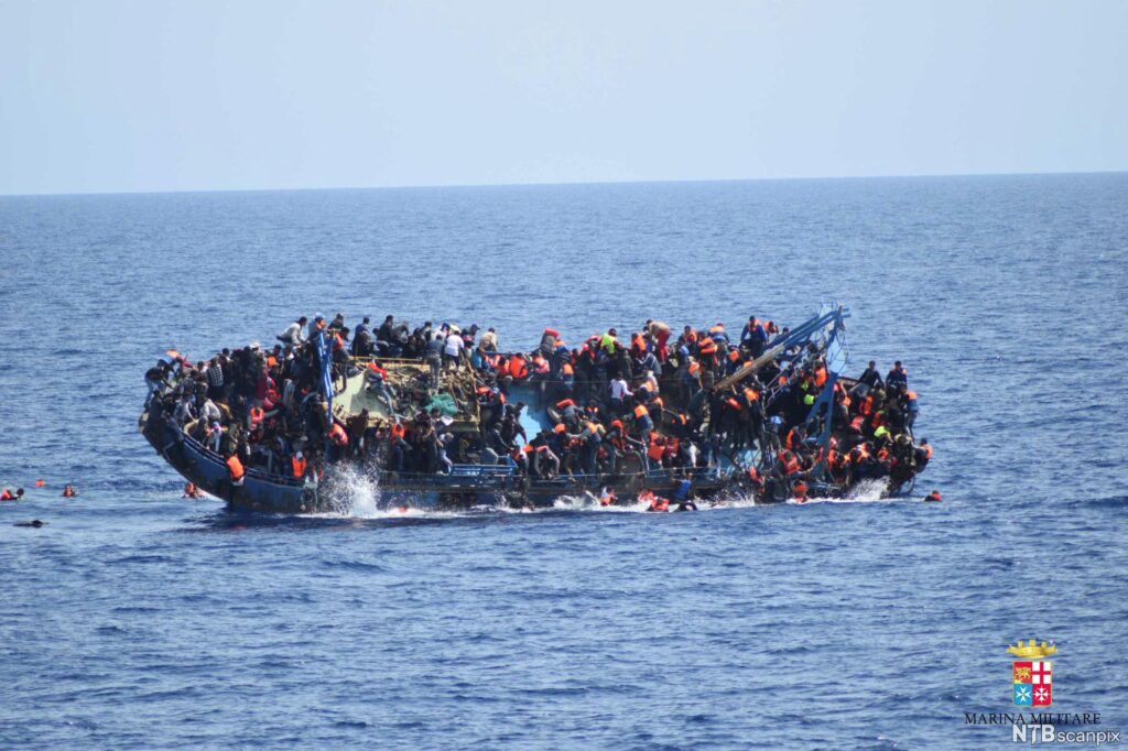 An overcrowded refugee boat capsizes in the Mediterranean